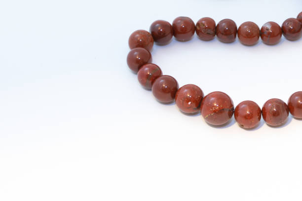 istock Brown jasper beads isolated on white background 1207758447