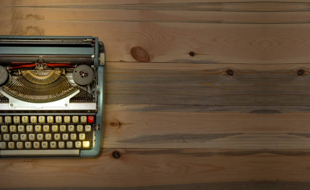 istock Vintage typewriter with wooden banner background 1207760474