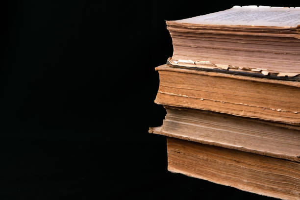 istock Stack of ancient books with yellowed shabby pages 1207761632