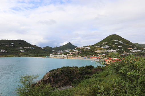 Beautiful views of the Little Bay, hills covered with lush greenery and beautiful houses and hotels on the beach, turquoise Caribbean Sea from Fort Amsterdam in Philipsburg, St. Maarten.