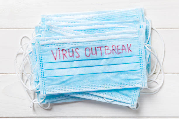 istock virus outbreak word written on medical mask. virus outbreak text on protective mask for your desing, Wuhan Coronavirus, 2019-nCoV. concept top view 1207763143