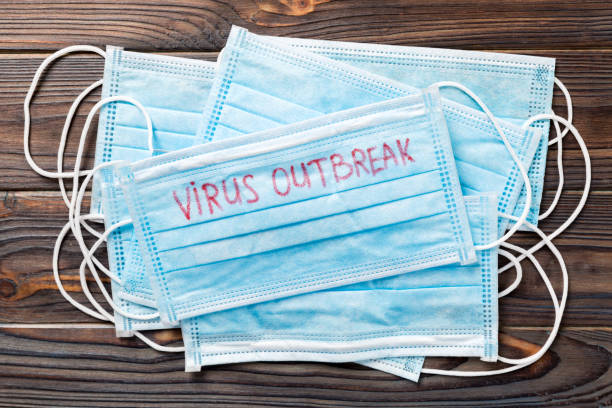 istock virus outbreak word written on medical mask. virus outbreak text on protective mask for your desing, Wuhan Coronavirus, 2019-nCoV. concept top view 1207763936