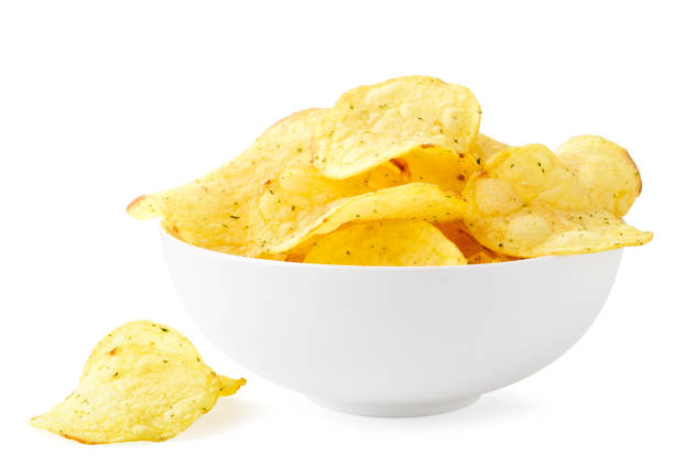 istock Potato chips with seasonings in a plate and scattered on a white. Isolated 1207764179