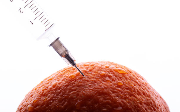 istock Injection in orange fruit as cellulite concept 1207766193