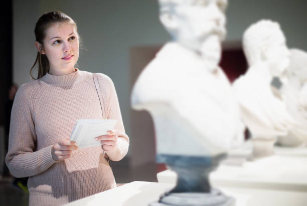 istock Female with guidebook in museum of ancient sculpture 1207772688
