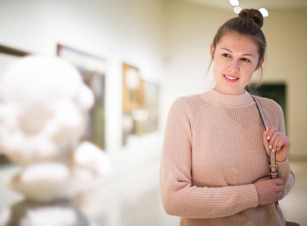 istock Woman standing in art museum 1207772713