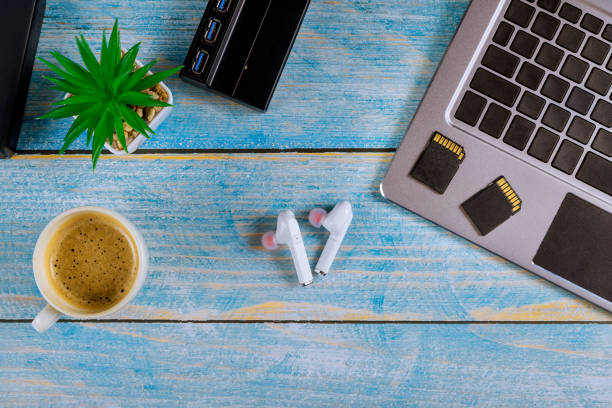 External hard disk and USB3.0 reader of memory SD cards on laptop keyboard with glasses and coffee, Backup file every photographer use external storage