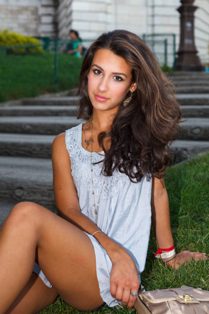 Beautiful young woman outside the historical Sacre Coeur Cathedral in Paris.