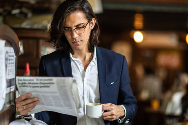 istock Businessman standing in cafe and reading newspapers and drinking coffee 1207777518