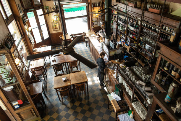 waitress setting things up before start of working day in traditional coffee shop in buenos aires - gastro pub imagens e fotografias de stock