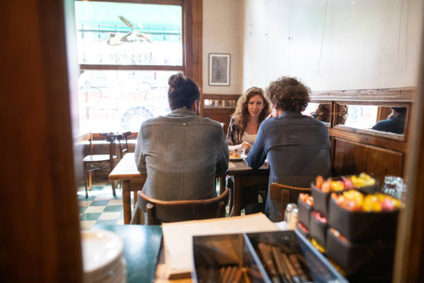istock Colleagues relaxing and talking at cafe after work 1207777951