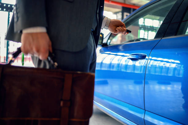 istock Businessman in the garage unlocking his car. 1207782468