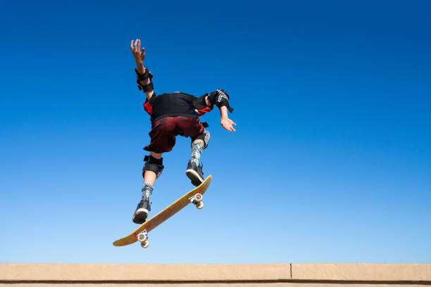 istock Young Boy on A Skateboard Jumping Into the Air 1207786062