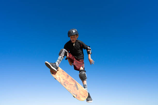 istock Young Boy on A Skateboard Jumping Into the Air 1207786247
