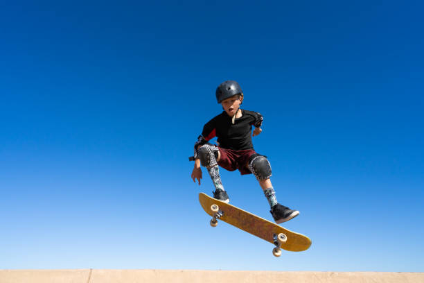 istock Young Boy on A Skateboard Jumping Into the Air 1207786352