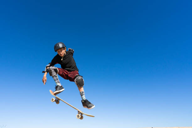 istock Young Boy on A Skateboard Jumping Into the Air 1207786411