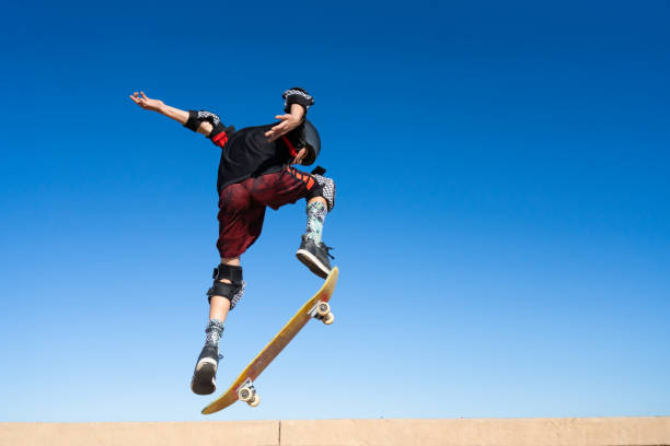 istock Young Boy on A Skateboard Jumping Into the Air 1207786489