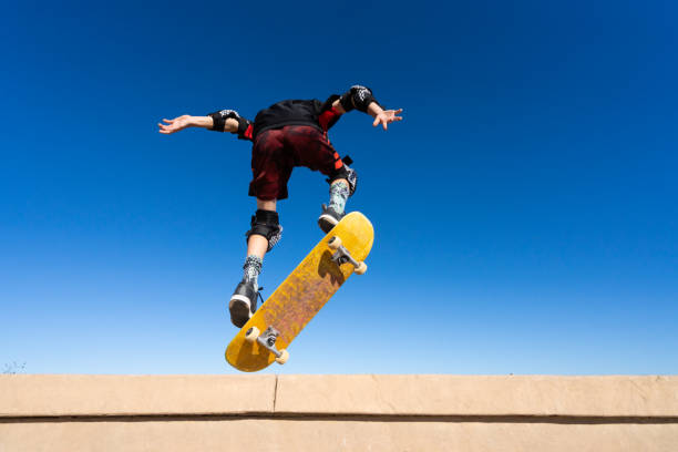 istock Young Boy on A Skateboard Jumping Into the Air 1207786565