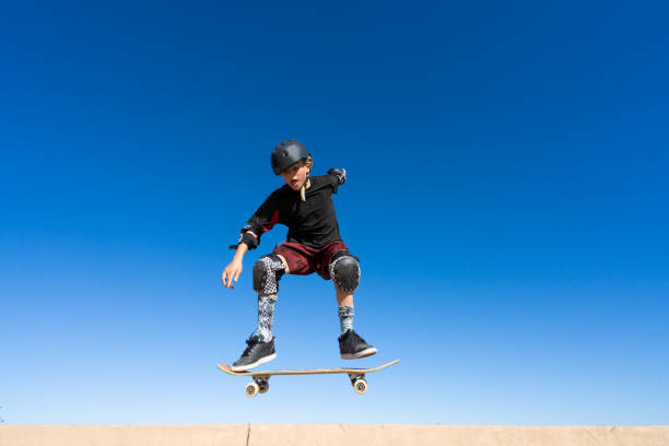 istock Young Boy on A Skateboard Jumping Into the Air 1207786841