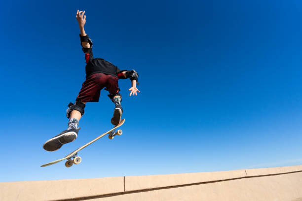 istock Young Boy on A Skateboard Jumping Into the Air 1207786907