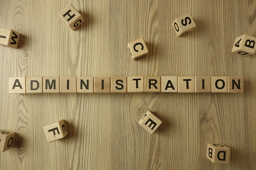 Word administration from wooden blocks on desk