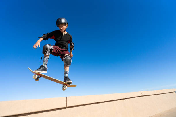 istock Young Boy on A Skateboard Jumping Into the Air 1207786948