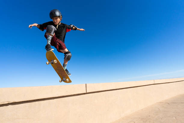 istock Young Boy on A Skateboard Jumping Into the Air 1207787110