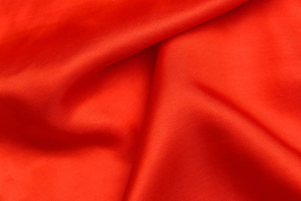istock fabric texture. abstract background with soft waves. Smooth elegant red silk or satin luxury cloth 1207793794