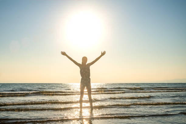 istock girl at sea hands is wide spread 1207798317