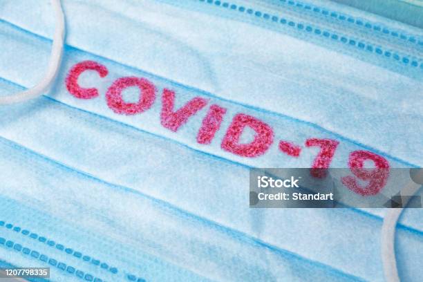 Blue Medical Disposable Face Mask With Covid19 Printed On It Covid19 Wuhan Novel Coronavirus Pneumonia Gets Official Name From Who Covid19 Disposable Breath Filter Face Mask With Earloop Stock Photo - Download Image Now
