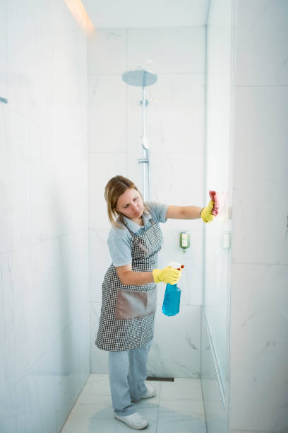 istock Woman cleaning shower stall 1207800625