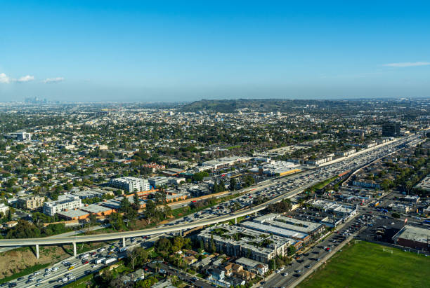 Aerial View high above the 405 Freeway in Los Angeles looking East Aerial View high above the 405 Freeway in Los Angeles looking south east with Palms and Culver City in the background highway 405 photos stock pictures, royalty-free photos & images