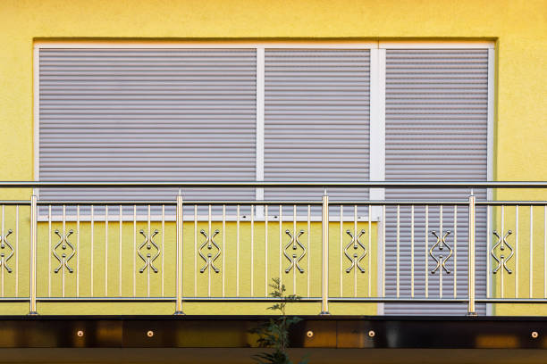 fence. chrome stainless steel fence on balcony in front of balcony door and window