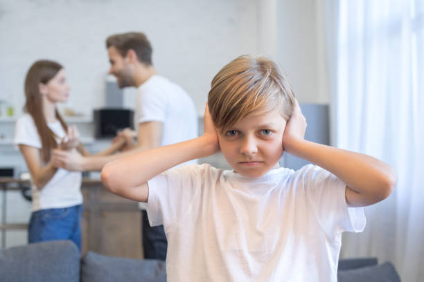 istock Sad desperate little boy during parents quarrel at home 1207805607