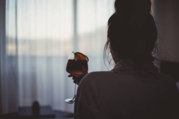 istock A young woman in a bathrobe enjoys bed and drinks a cocktail 1207809686