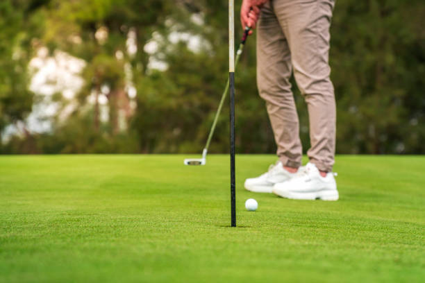 joven irreconocible jugando al golf como actividad de fin de semana. - golf power golf course challenge fotografías e imágenes de stock