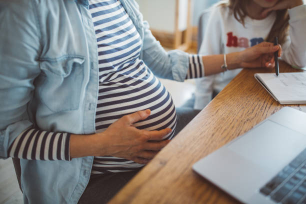 istock Mother helping daughter with homework 1207814419