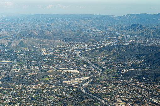 High above the Ventura Freeway 101 in Newbury Park looking east over Thousand Oaks, Highway 23 to the left, Westlake Village and Agora Hills in the distance. Saratoga Hills, Cheeseboro and Palo Comado Canyon and Santa Monica Mountains in the distance.