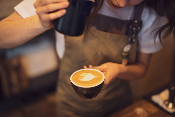 istock Closeup cup of coffee with pouring milk 1207816156