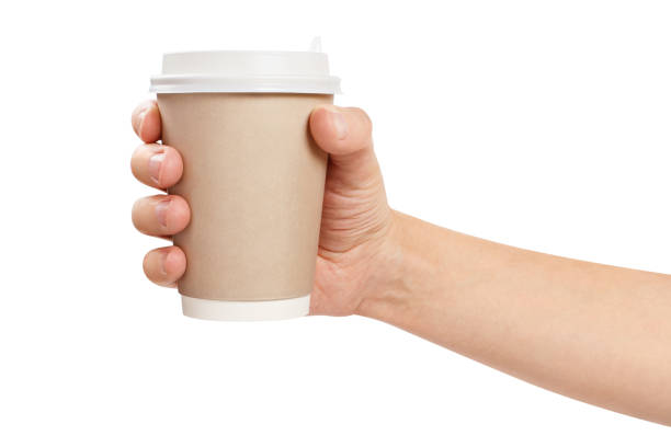 istock Hand holding paper coffee cup on white 1207816459