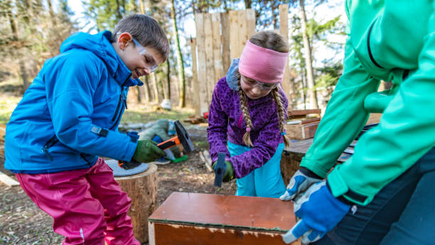 istock Kids hammering nails into a wooden box 1207817126