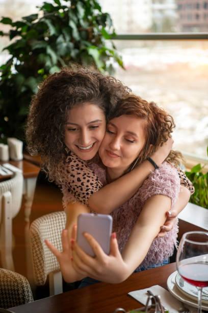 istock Happy women taking selfie in restaurant 1207820223