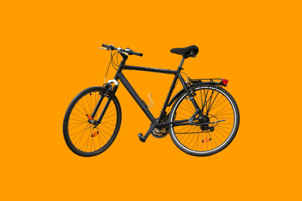 Old black bike isolated on orange background