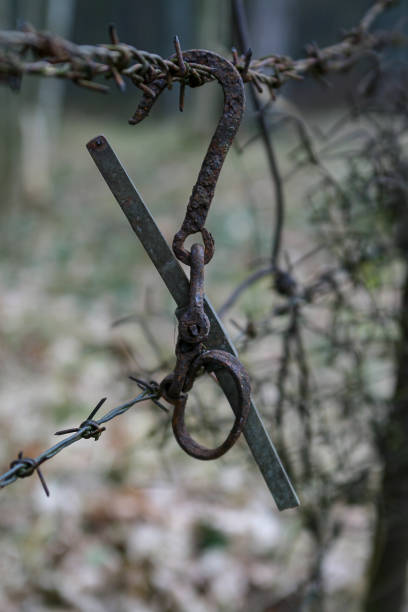 istock A rusty old hook hanged on an old rusty barbed wire fence 1207825915