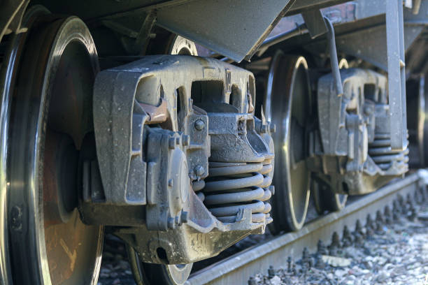 istock Dirty rustic train suspension and wheels on a train track 1207826071