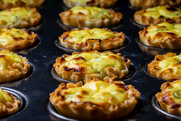 istock Cheese filled filo pastry in muffin pan. 1207832570