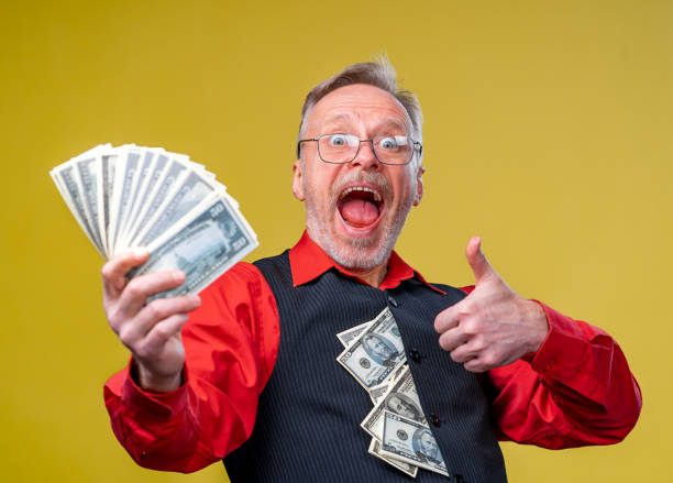 istock Crazy business man admiring dollar bills giving thumb up. 1207836847