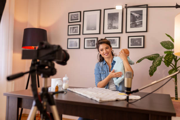 istock Influencer recording video about baby burping positions 1207837040