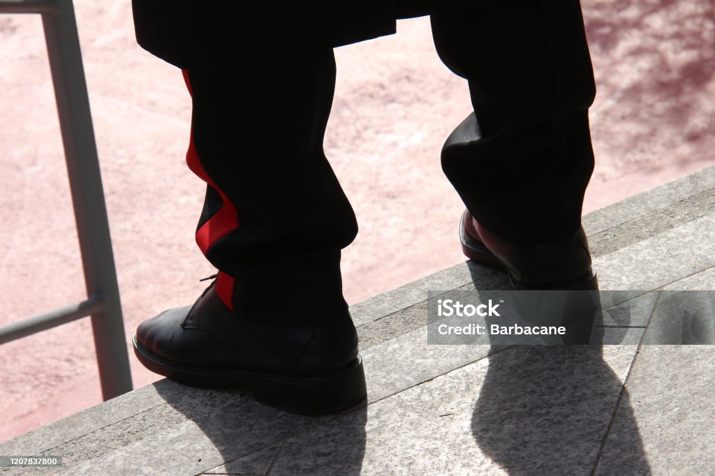 Edge of the trousers of the Italian Carabiniere Fund of the leg, trousers of an Italian policeman with the red line. Carabinieri Stock Photo