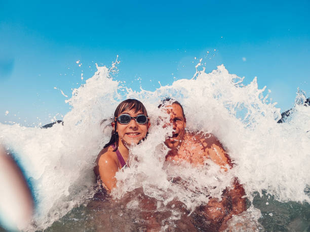istock Father and daughter having fun on the beach 1207839231